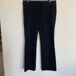 Boot cut, slight stretch. Wide waist band. Hook/eye closure and zip.